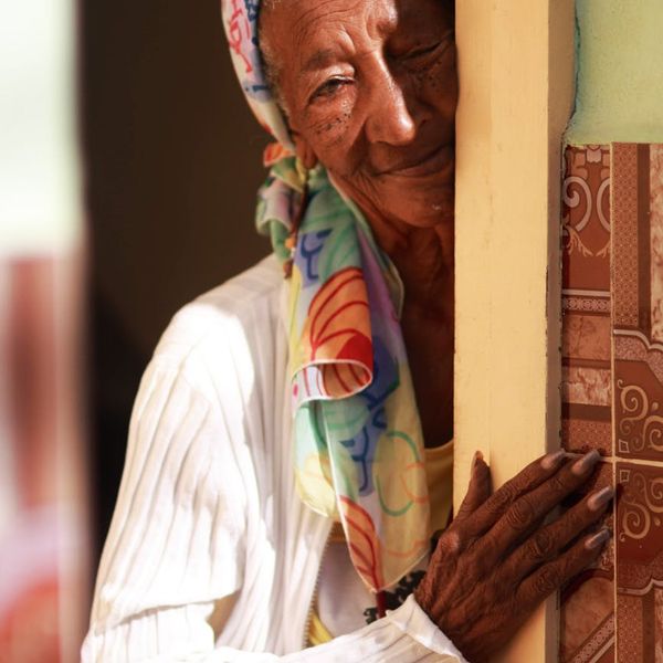 Person smiling peacefully after a gentle exercise session, looking refreshed.